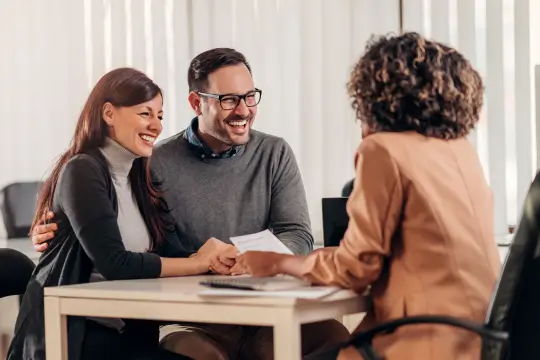 a man and a woman sitting at a table in an office